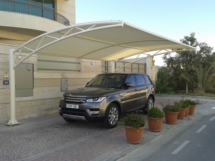 Car parked under UV protected parking shade in Karachi showing sunlight blocking and heat reduction effect for vehicle safety