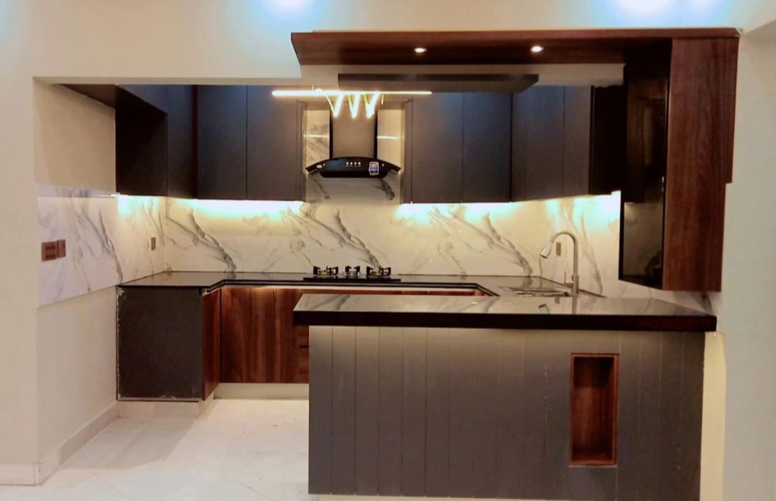 Modern matte Tactile finish kitchen cabinets with counter top. designed and installed by Etminaan Services in Karachi.