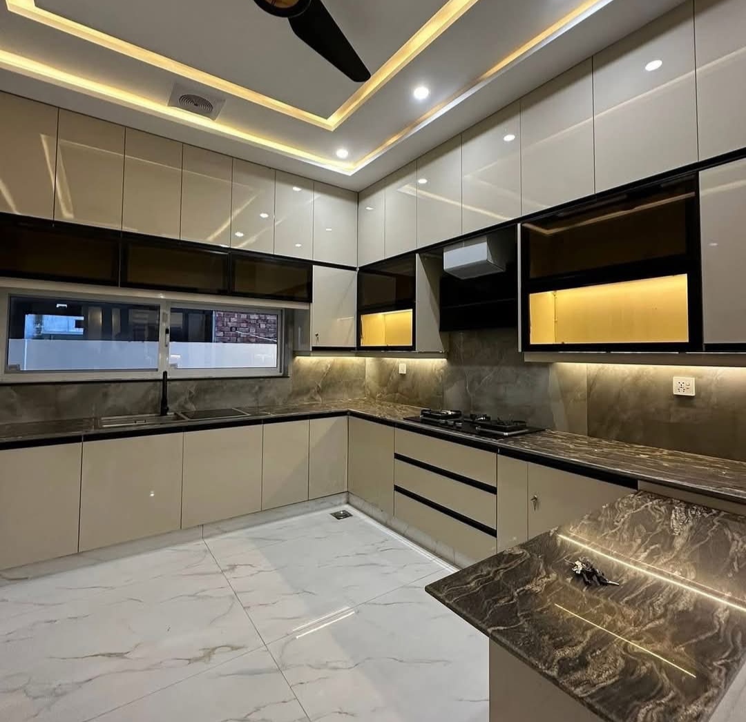 Modern luxury island kitchen design with seating area installed in Karachi by Etminaan Services.