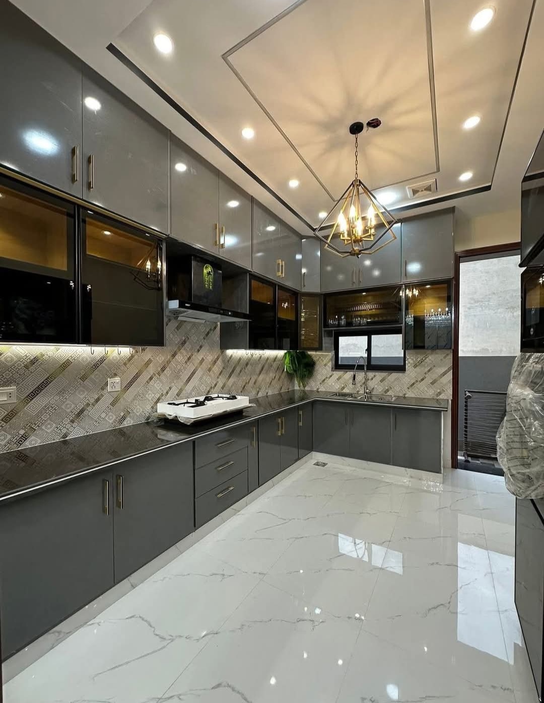 Super gloss finish modern kitchen cabinets installed by Etminaan Services in Karachi.
