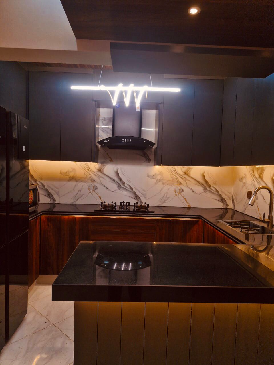 Modern matte finish kitchen cabinets designed and installed by Etminaan Services in Karachi.