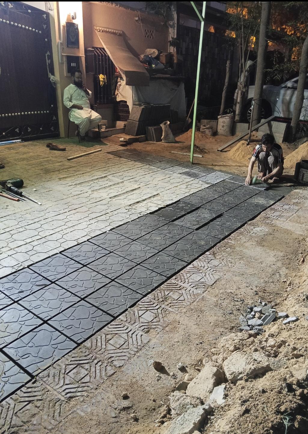 Professional tuff tile installation work on a footpath by Etminaan Services, providing durable masonry services in Karachi.