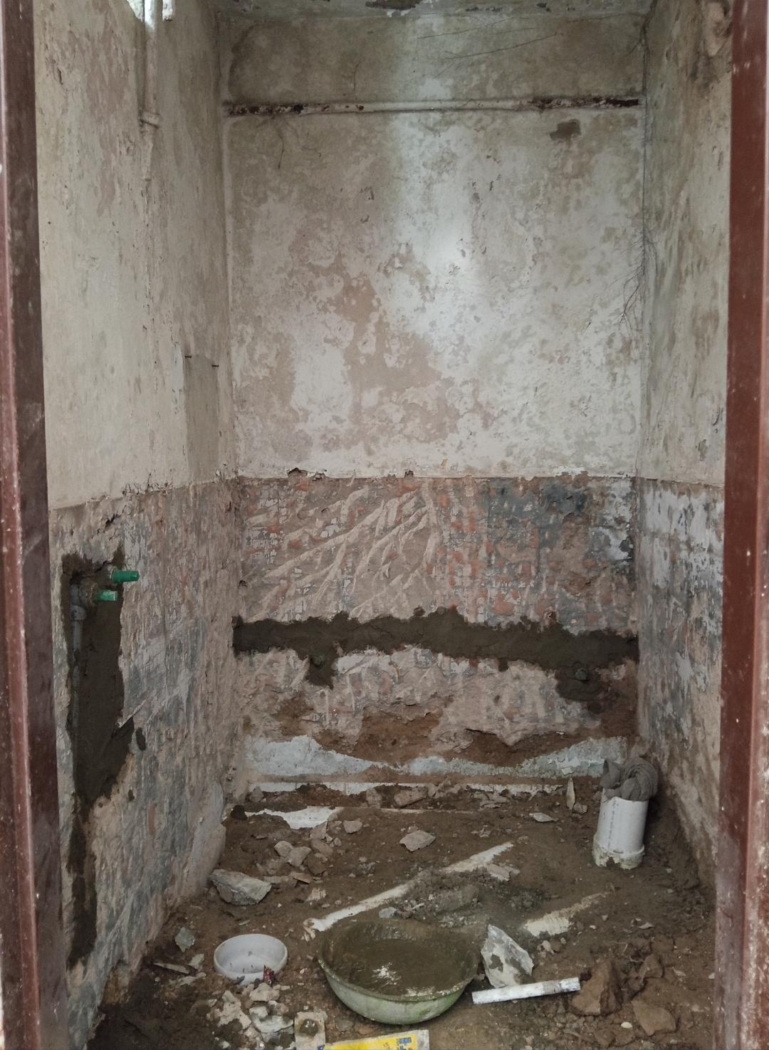 Bathroom before renovation showing walls prepared for plastering, tile installation, and sanitary work by Etminaan Services, offering masonry services in Karachi.