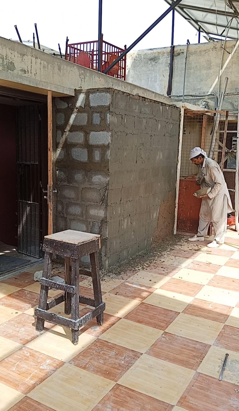 Professional masonry work in progress on a bungalow roof by Etminaan Services, delivering expert masonry services in Karachi.